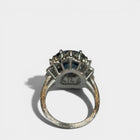 Ring «Entourage» in white gold 750 with 1 sapphire ca. 7.5ct, 18 diamonds brilliant cut ca. G-H/si 0.70ct, 55 dia-monds eight facet cut 8/8 ca. G-H/si 1.40ct, fingersize: 57,
weight: 13.4g