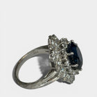 Ring «Entourage» in white gold 750 with 1 sapphire ca. 7.5ct, 18 diamonds brilliant cut ca. G-H/si 0.70ct, 55 dia-monds eight facet cut 8/8 ca. G-H/si 1.40ct, fingersize: 57,
weight: 13.4g