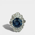 Ring «Entourage» in white gold 750 with 1 sapphire ca. 7.5ct, 18 diamonds brilliant cut ca. G-H/si 0.70ct, 55 dia-monds eight facet cut 8/8 ca. G-H/si 1.40ct, fingersize: 57,
weight: 13.4g
