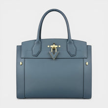 Secondtimearound Louis Vuitton Steamer MM bag in blue textured leather with gold hardware and a V-shaped clasp.