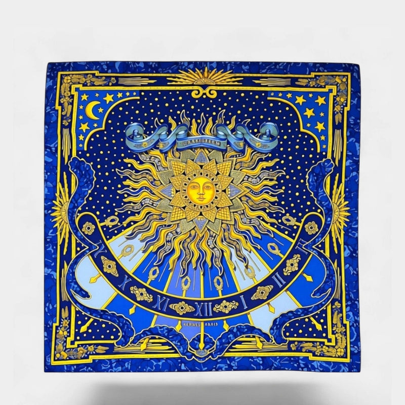 Secondtimearound Hermes Carpe Diem silk scarf featuring a sun motif, celestial elements, and Roman numerals in blue and yellow.