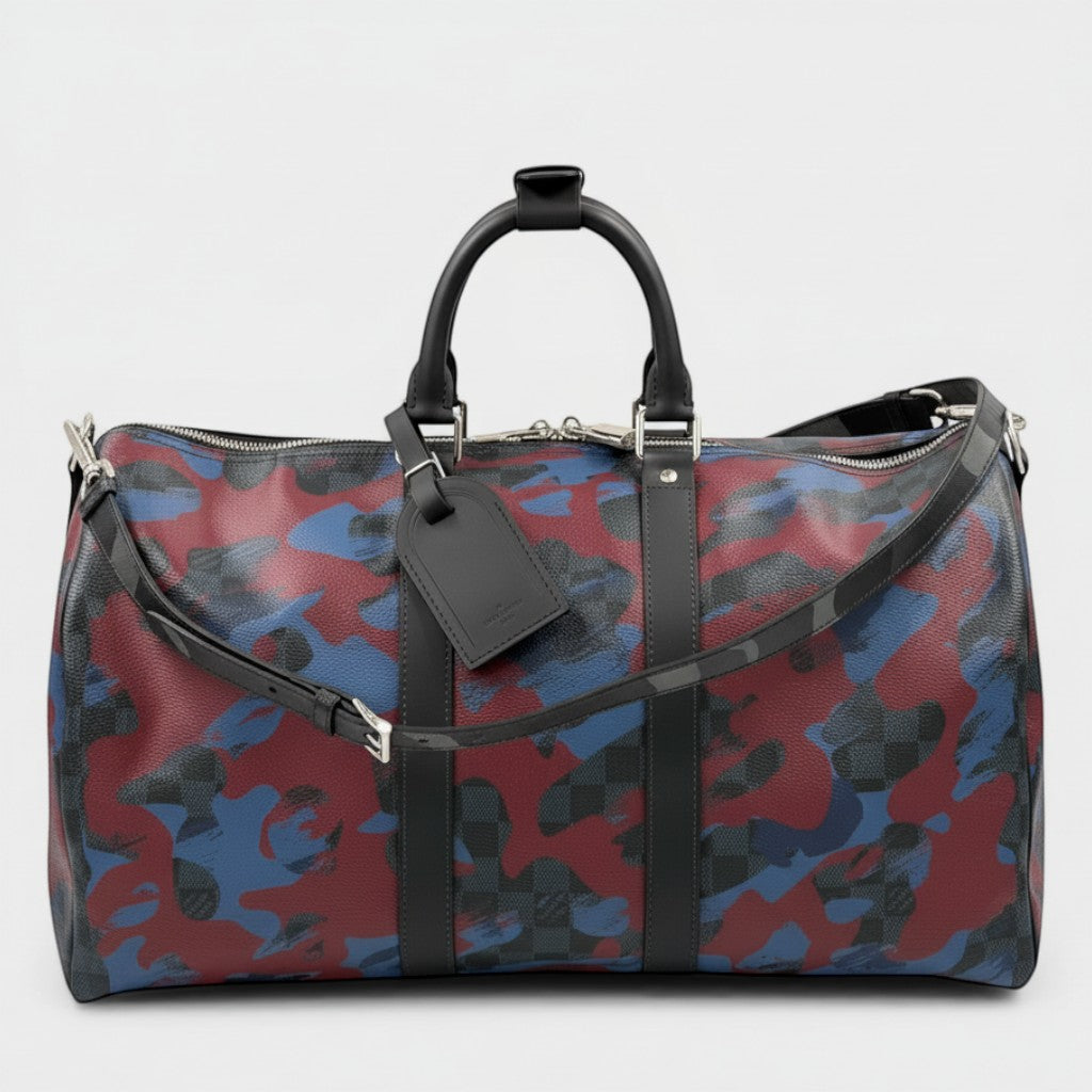 Secondtimearound Louis Vuitton Keepall Bandouliere 45 bag in Damier Cobalt Camouflage print with black leather trim and strap.