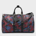 Secondtimearound Louis Vuitton Keepall Bandouliere 45 bag in Damier Cobalt Camouflage print with black leather trim and strap.