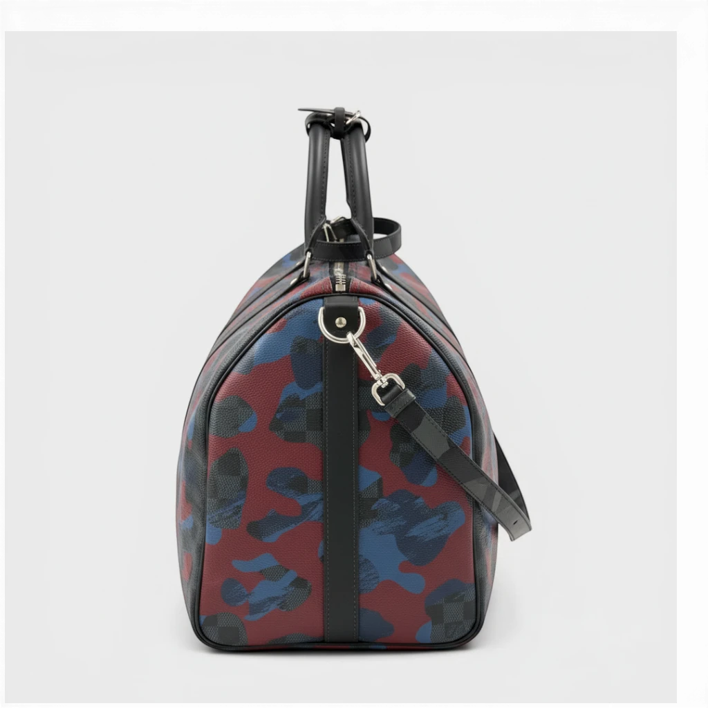 Secondtimearound Louis Vuitton Keepall Bandouliere 45 bag in Damier Cobalt Camouflage print with black leather trim and silver hardware.