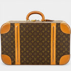 Secondtimearound Louis Vuitton Sirius 55 Monogram Canvas suitcase with leather trim and handle.