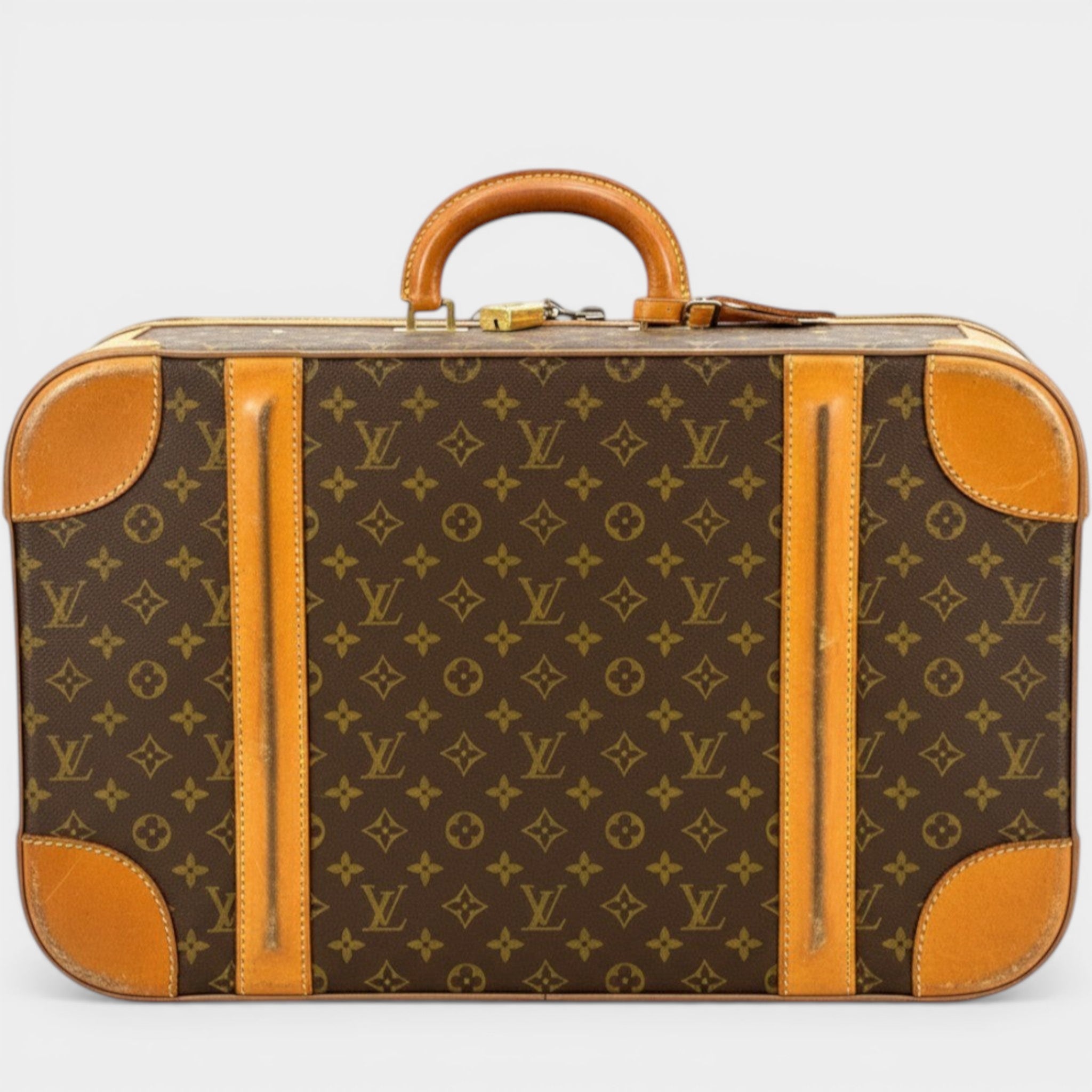 Secondtimearound Louis Vuitton Sirius 55 Monogram Canvas suitcase with leather trim and handle.