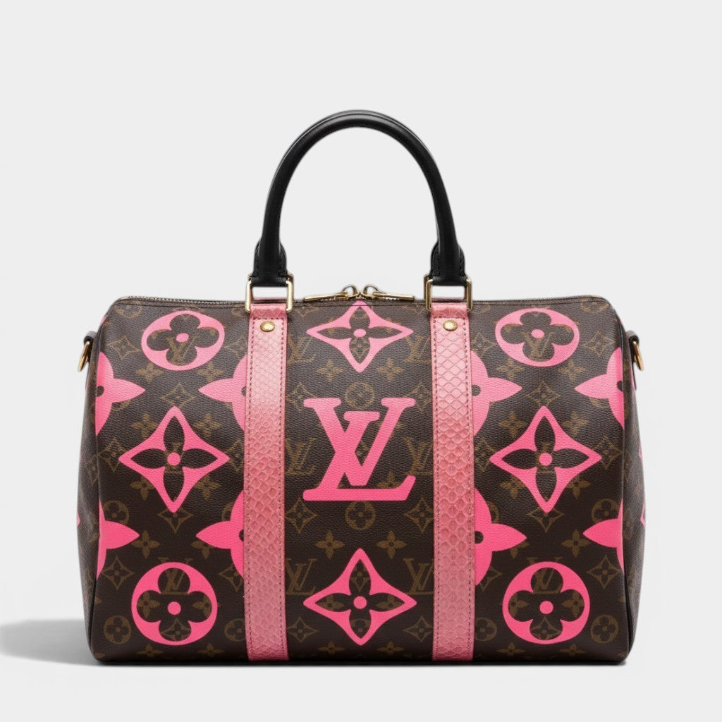 Secondtimearound Louis Vuitton Speedy 35 bag in brown monogram canvas with pink LV logo and flower print, black leather handles, and pink trim.
