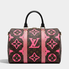Secondtimearound Louis Vuitton Speedy 35 bag in brown monogram canvas with pink LV logo and flower print, black leather handles, and pink trim.