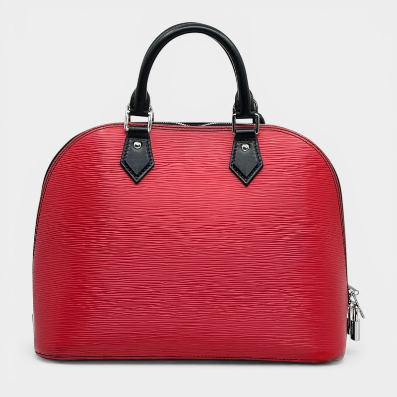 Secondtimearound red embossed leather satchel bag with black handles and patent accents. Classic satchel silhouette with top handles.